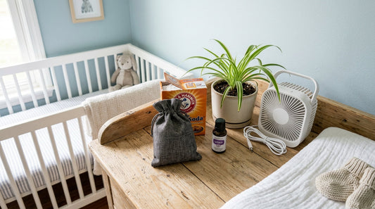 Flatlay of natural nursery air freshener items including baking soda, charcoal bag, essential oil, plant, and fan on changing table